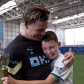 Jack Grealish with Finlay. Credit: Man City on twitter