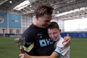 Jack Grealish with Finlay. Credit: Man City on twitter