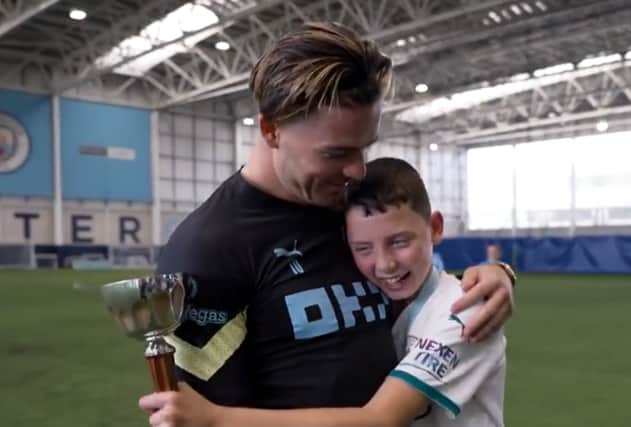 Jack Grealish with Finlay. Credit: Man City on twitter