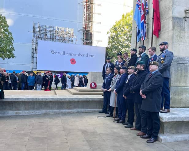 Veterans pose for a photo at the War Memorial on St Peter’s Square on Remembrance Sunday. Credit: Manchester World
