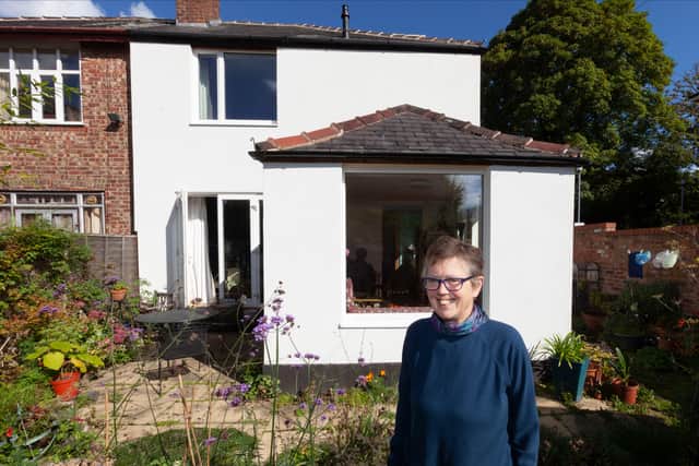 Jane Ward outside her retrofitted house in Whalley Range. Credit: Your Home Better