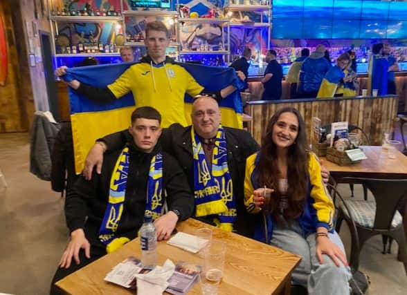 Christina and Alex Senechko with dad Oleh and a family friend supporting Ukraine against Wales in the recent World Cup football qualifiers