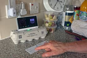 Pensioner Diane Skidmore examines her smart meter in London. 