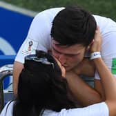 England’s defender Harry Maguire kisses his girlfriend Fern Hawkins after the Russia 2018 World Cup Group G football match between England and Panama at the Nizhny Novgorod Stadium in Nizhny Novgorod on June 24, 2018.  (Credit JOHANNES EISELE/AFP via Getty Images)