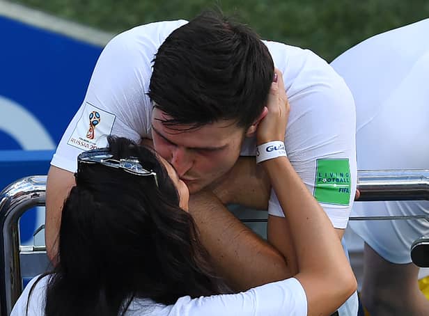 <p>England’s defender Harry Maguire kisses his girlfriend Fern Hawkins after the Russia 2018 World Cup Group G football match between England and Panama at the Nizhny Novgorod Stadium in Nizhny Novgorod on June 24, 2018.  (Credit JOHANNES EISELE/AFP via Getty Images)</p>