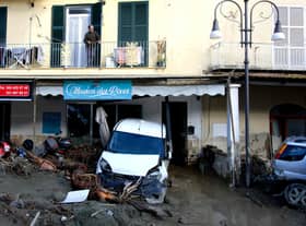 A man looks out from the balcony of his home in Casamicciola on November 27, 2022, following heavy rains that caused a landslide on the island of Ischia, southern Italy. - Italian rescuers were searching for a dozen missing people on the southern island of Ischia after a landslide killed at least one person, as the government scheduled an emergency meeting. A wave of mud and debris swept through the small town of Casamicciola Terme early Saturday morning, engulfing at least one house and sweeping cars down to the sea, local media and emergency services said. (Photo by Eliano IMPERATO / AFP) (Photo by ELIANO IMPERATO/AFP via Getty Images)