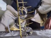 Liat Segal & Dr. Yasmine Meroz's artwork being unveiled on the ISS where microgravity allows the water to stick to the metal frame in large globules