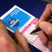  A punter fills out a National Lottery ticket.