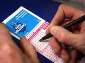  A punter fills out a National Lottery ticket.