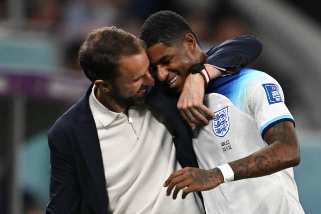 England’s coach Gareth Southgate congratulates Marcus Rashford as he is substituted after scoring two goals Wales (Photo by PAUL ELLIS/AFP via Getty Images)