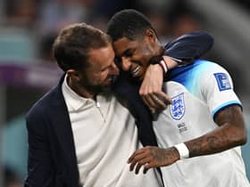 England’s coach Gareth Southgate congratulates Marcus Rashford as he is substituted after scoring two goals Wales (Photo by PAUL ELLIS/AFP via Getty Images)