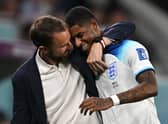 England’s coach Gareth Southgate congratulates Marcus Rashford as he is substituted after scoring two goals Wales (Photo by PAUL ELLIS/AFP via Getty Images)