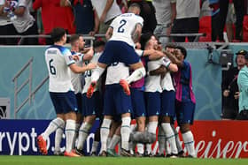 England players celebrate one of Marcus Rashford’s goals vs Wales.