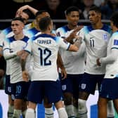 England players celebrate Marcus Rashford’s goal vs Wales.