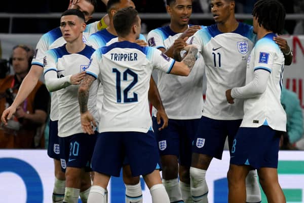 England players celebrate Marcus Rashford’s goal vs Wales.