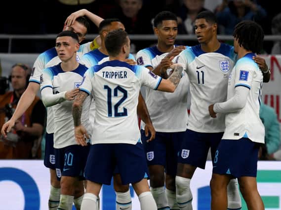 England players celebrate Marcus Rashford’s goal vs Wales.