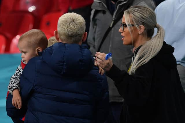 England's midfielder Phil Foden (L) and his partner Rebecca Cooke (R) are seen in the stands at the end of the UEFA EURO 2020 Group D football match between Czech Republic and England at Wembley Stadium in London on June 22, 2021. (Photo by JUSTIN TALLIS / POOL / AFP) (Photo by JUSTIN TALLIS/POOL/AFP via Getty Images)