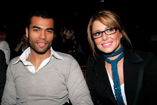  England football player Ashley Cole and singer Cheryl Tweedy of Girls Aloud attend the Julien Macdonald fashion show as part of London Fashion Week Autumn/Winter 2006/7 at the Freemason's Hall on February 14, 2006 in London.  (Photo by Gareth Cattermole/Getty Images)