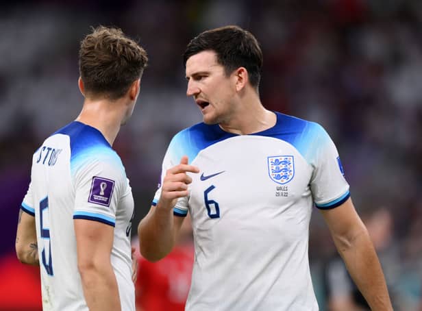 <p>John Stones (L) and Harry Maguire of England speak during the FIFA World Cup Qatar 2022 Group B match between Wales and England  (Photo by Justin Setterfield/Getty Images)</p>