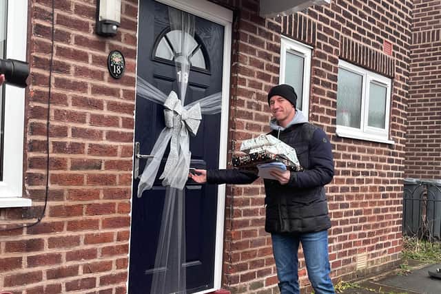 Footballer Nicky Butt about to surprise a resident in Gorton with a Christmas gift. Credit: Manchester World
