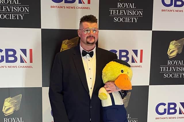 John Junior and Charlie the duck on the red carpet at an awards ceremony
