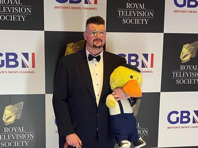 John Junior and Charlie the duck on the red carpet at an awards ceremony