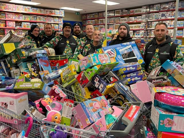 Reese, far right, and his team with some of hundreds of toys they bough from Smyth's Toy Shop