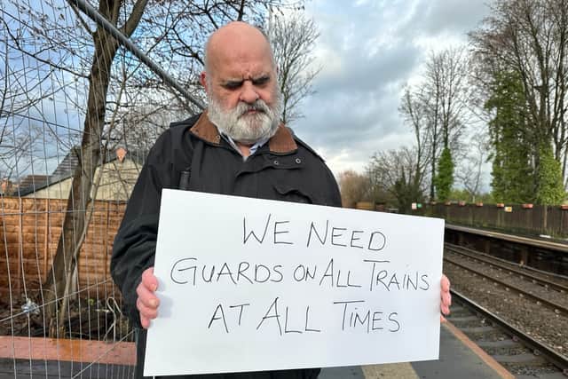 Kevin Greenan at Mills Hill station in Middleton sending a message about the importance of keeping guards on trains. Photo: Sarah Gayton