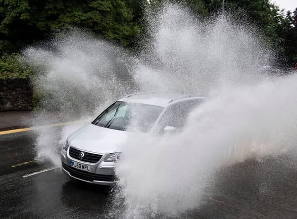 A car drives through floodwater (Photo by Matthew Horwood/Getty Images)
