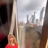Commuters have rallied to keep a cardboard cut-out of Taylor Swift on display in a flat window in Manchester Credit: Red Redmond / SWNS