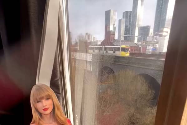 Commuters have rallied to keep a cardboard cut-out of Taylor Swift on display in a flat window in Manchester Credit: Red Redmond / SWNS