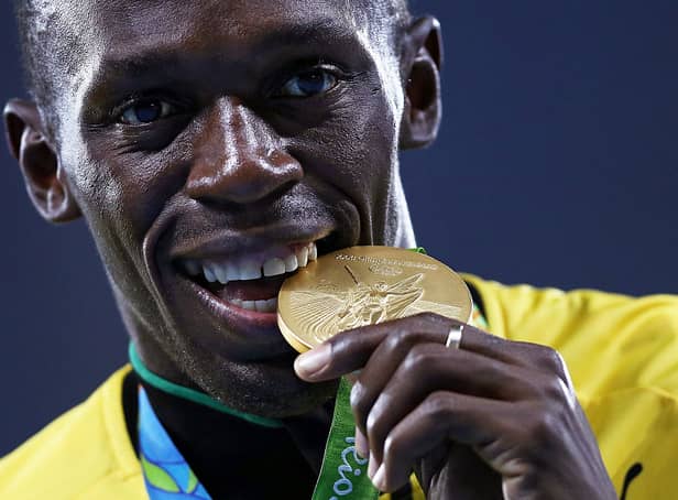 <p>Gold medalist Usain Bolt of Jamaica stands on the podium during the medal ceremony for the Men’s 4 x 100 meter Relay on Day 15 of the Rio 2016 Olympic Games at the Olympic Stadium on August 20, 2016 in Rio de Janeiro, Brazil.  (Photo by Patrick Smith/Getty Images)</p>