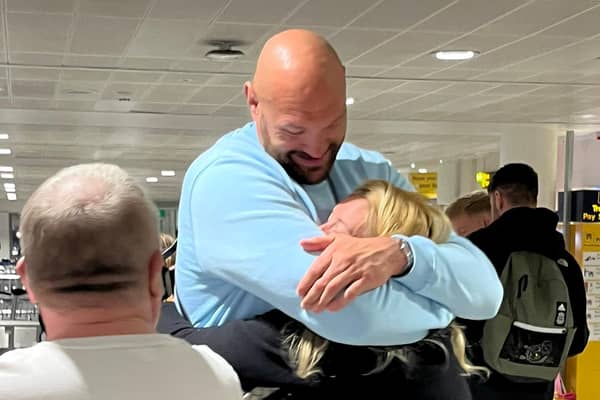 Tyson Fury proves he’s the people’s champion by chatting to fans and hugging wife Paris as they land back in Manchester Credit SWNS