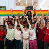 Youngsters and the team at the children’s library in Hulme celebrating its opening. Photo: Lizzie Henshaw