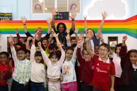 Youngsters and the team at the children’s library in Hulme celebrating its opening. Photo: Lizzie Henshaw