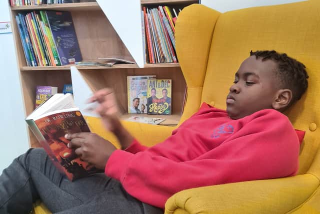 Amari Duhaney reading in the new children’s library in Hulme. Photo: Z-arts