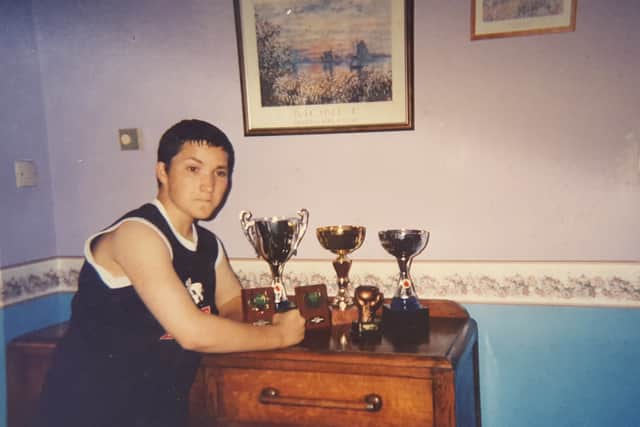 Oliver Sykes aged 15 with his boxing trophies