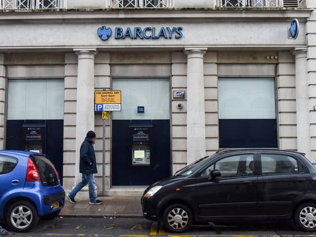 A man walks past a Barclays bank, in the Channel island's port capital Saint Helier, on December 11, 2022. (Photo by Sebastien SALOM-GOMIS / AFP) (Photo by SEBASTIEN SALOM-GOMIS/AFP via Getty Images)
