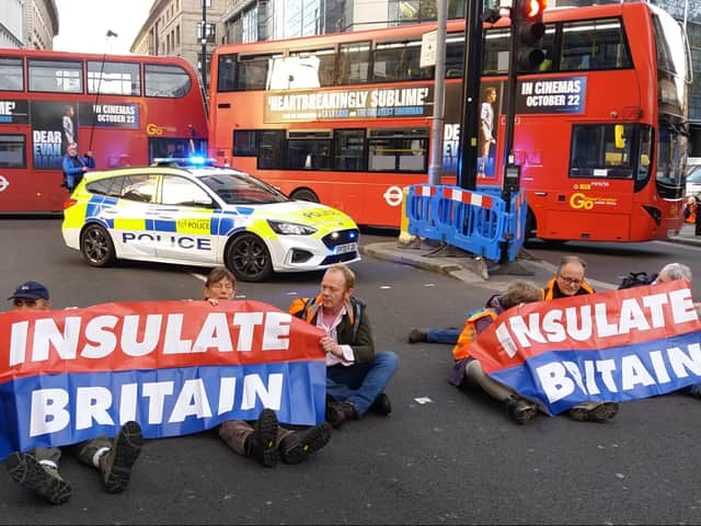 Insulate Britain activists including Rev Jonathan Coleman (second from right) taking part in the roadblock at Bishopsgate in London