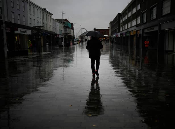 Dismal weather heralds the arrival of the UK Chancellor’s Autumn Statement as people shop in the centre of Bolton.