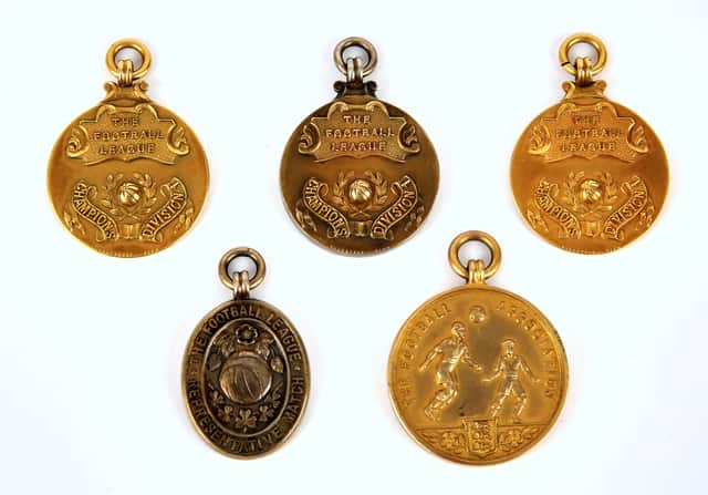 Johnny Berry’s league championship medals, together with his 1957 Football Association Challenge Cup Runner’s Up medal, and the Football League Representative Match medal from 1954 for a match against the Football League of Ireland Credit: EwbanksAuctioneers / SWNS