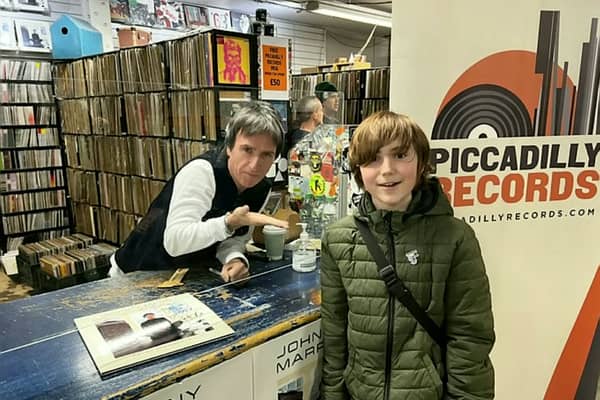 John Denton with his guitar hero Johnny Marr at Piccadilly Records, Manchester. Credit: Phil Denton / SWNS
