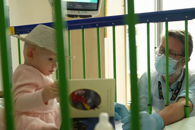 Professor Simon Jones with Teddi at the Royal Manchester Children’s Hospital. Photo: BBC