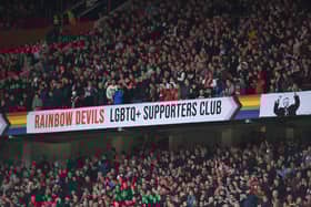 The Rainbow Devils LGBTQ+ Supporters club banner is shown in the East stand during the Premier League match between Manchester United and Newcastle United at Old Trafford on October 16, 2022
