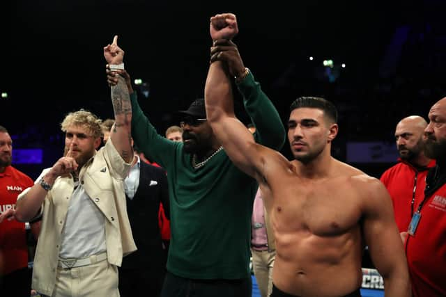 Boxer Derek Chisora holds the hands of Jake Paul and Tommy Fury as they face off, ahead of their upcoming fight on the 26th of February . (Photo by James Chance/Getty Images)