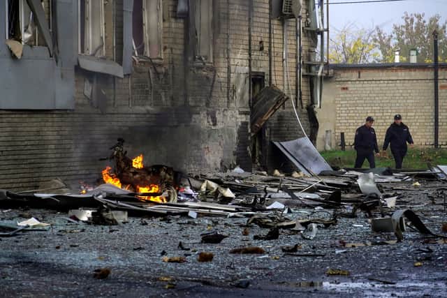 Police officers walk at the site of a car bomb explosion in Melitopol in southern Ukraine on October 25, 2022 Credit Getty