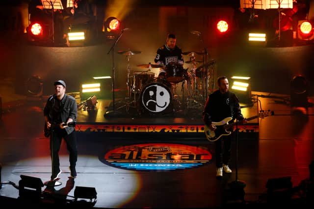 Patrick Stump, Andy Hurley, and Pete Wentz of Fall Out Boy perform onstage during the 2023 NHL All-Star Game