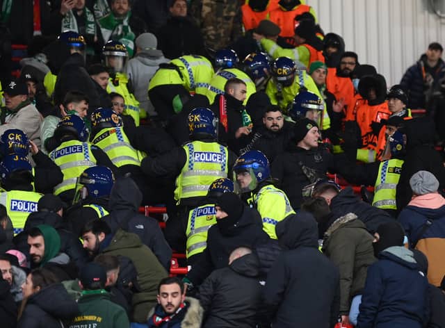 Police are seen in the stands with Real Betis tackling the disorder in the Man Utd game Credit: Getty