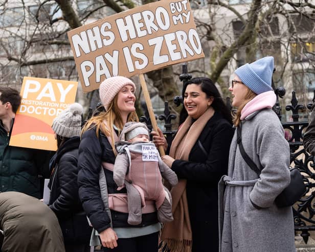 Demonstrators hold placards as they take part in a protest by junior doctors. Picture: NIKLAS HALLE’N/AFP via Getty Images
