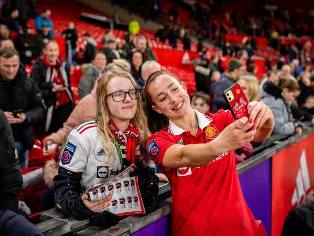 United defender Maya Le Tissier poses for a selfie with a fan at Old Trafford.
